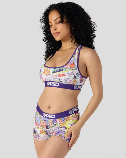 Woman wearing Care Bears comic-print sports bra and matching boy shorts with purple trim and PSD waistband.