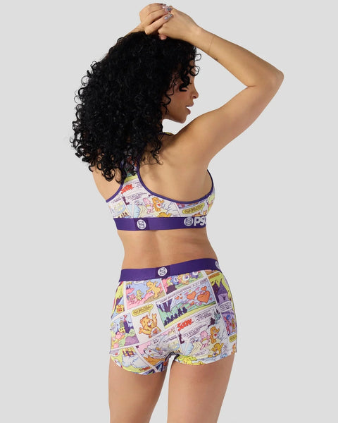 Woman wearing Care Bears comic print bra and shorts set with purple trim, shown from behind.