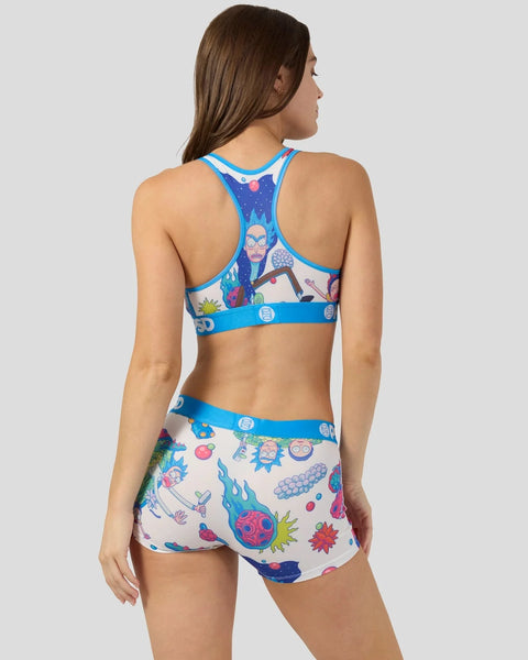 Woman wearing Rick and Morty-themed sports bra and shorts set with character graphics and colorful space designs.