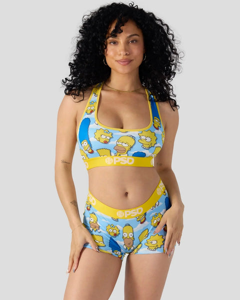 Two-piece swimsuit set with Simpsons character print in yellow and blue, featuring matching sports bra and shorts.