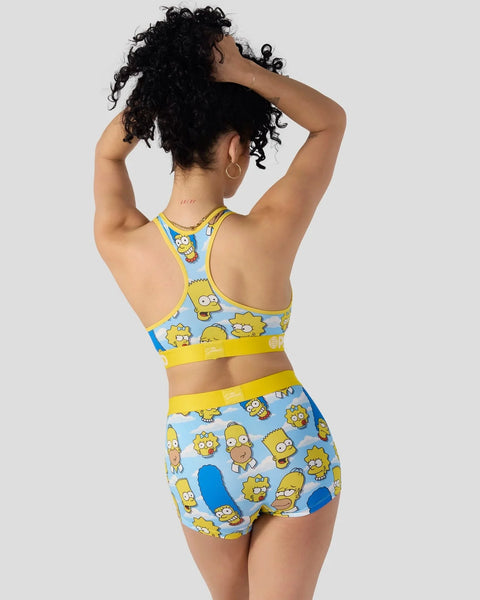 Simpsons character print racerback sports bra and shorts set in yellow and blue with repeated character heads.