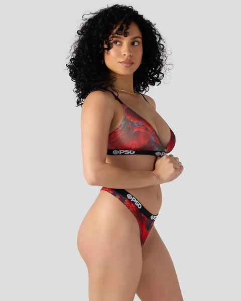 Woman wearing red and blue patterned bra and brief set with black PSD waistband.