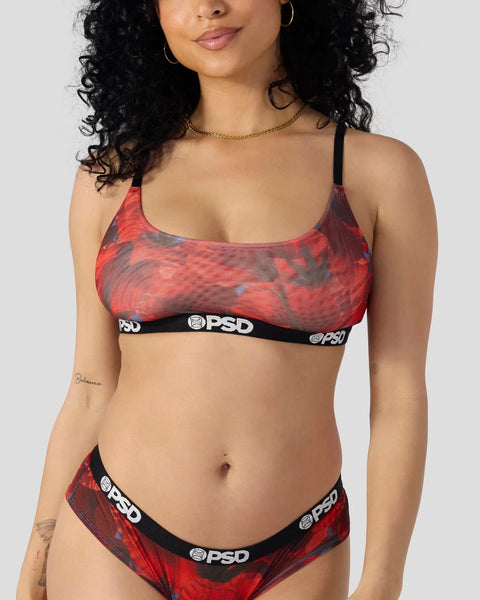 Woman wearing red and gray patterned sports bra and matching briefs with black PSD waistbands.