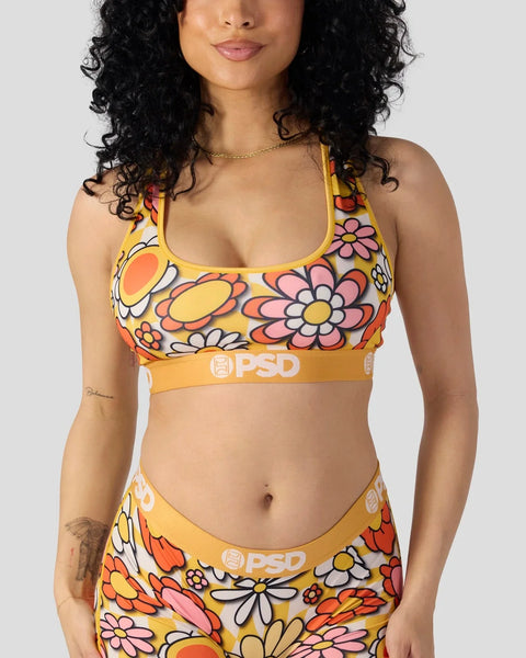 Yellow sports bra with multicolored floral print and PSD waistband.