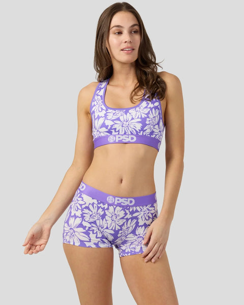 Purple and white floral print sports bra and shorts set with PSD branding.