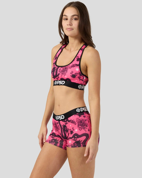 Pink and black dragon-patterned sports bra and shorts set with PSD waistband on model.