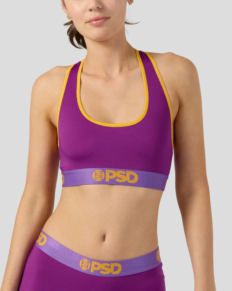Purple and yellow sports bra with racerback straps and PSD branded waistband.