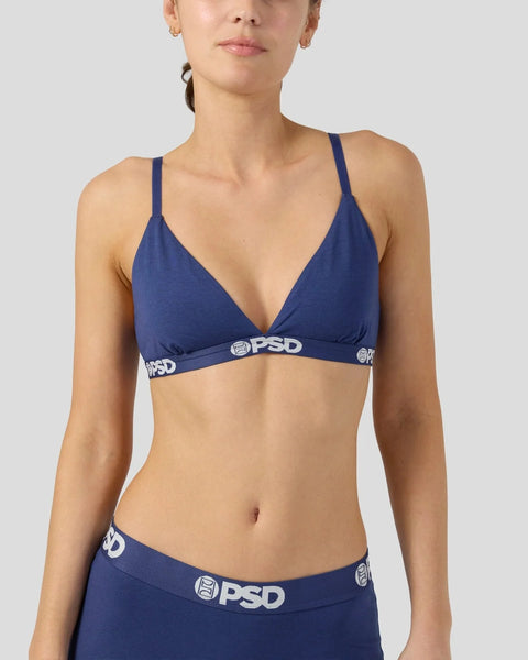 Navy bralette with thin shoulder straps and PSD waistband elastic, shown on model from chest to waist.