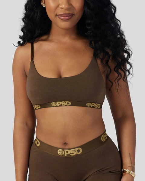 Woman wearing cocoa brown modal sports bra and underwear set with gold PSD branding on waistbands.