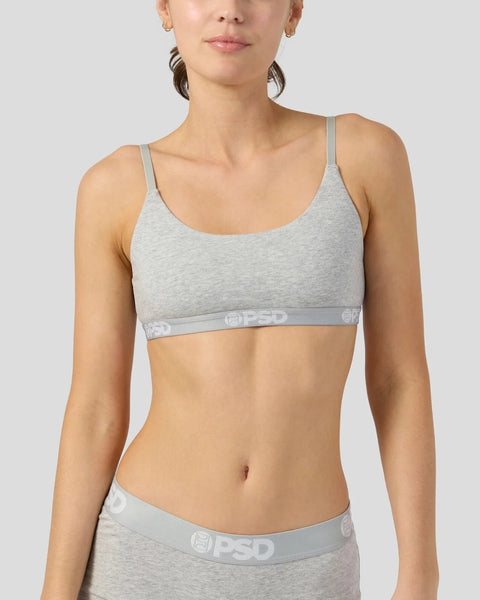 Woman wearing gray modal sports bra and underwear with branded waistband.