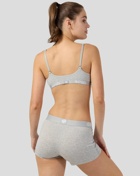 Woman wearing light gray modal bra and shorts with adjustable straps and elastic waistband, shown from back.