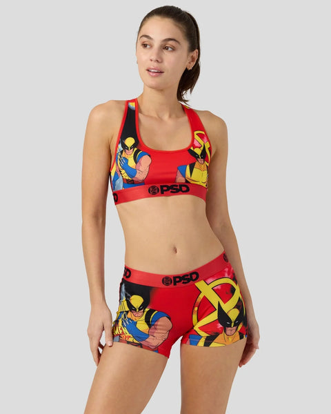 Woman wearing red sports bra and matching shorts with Wolverine character print and PSD branding.