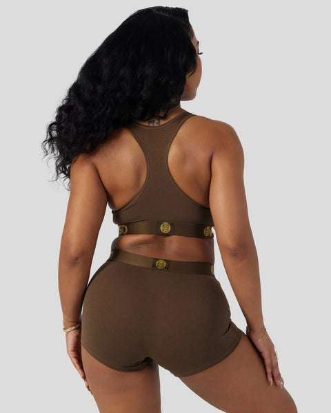 Cocoa-colored sports bra and shorts set with gold buckle accents, shown from the back.