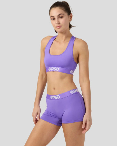 Purple racerback sports bra and matching shorts set with PSD branding on elastic bands.