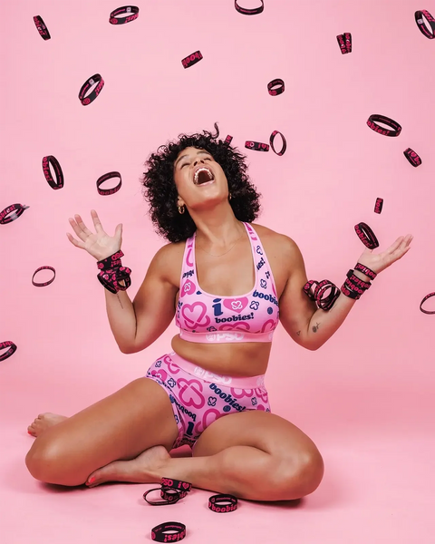 Woman wearing pink sports bra and matching briefs with 