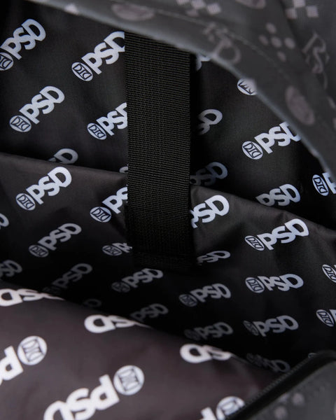 Black backpack material with repeated white logo print and black webbing strap detail.