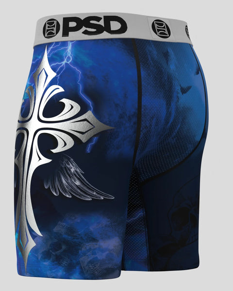 PSD brand shorts with blue and black design featuring white winged cross and lightning bolt graphics.