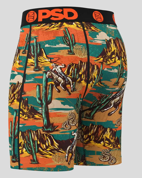 PSD boxer briefs with desert landscape print featuring cacti, tumbleweeds, cowboy, and snake motifs in orange, teal, and yell