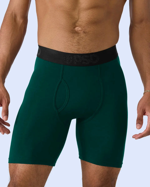 Man wearing deep green boxer briefs with black textured waistband.