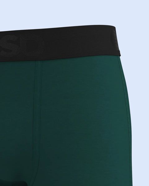 Deep green modal briefs with black waistband detail against light blue background.