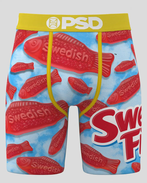 Red Swedish Fish candies on blue background, men's boxer briefs with yellow waistband and PSD branding.