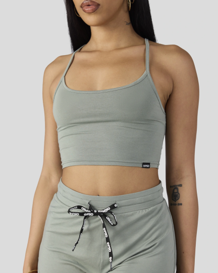 Sage green cami crop top and drawstring shorts sleep set on model with long dark hair.