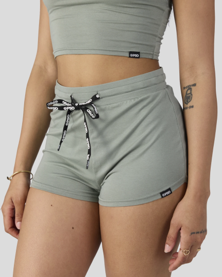 Sage green cami crop top and drawstring shorts sleep set on model.