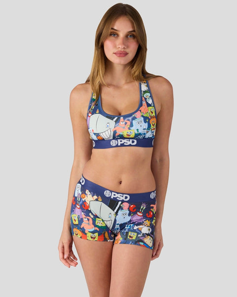 Woman wearing SpongeBob SquarePants-themed sports bra and shorts set with navy base and colorful character print.