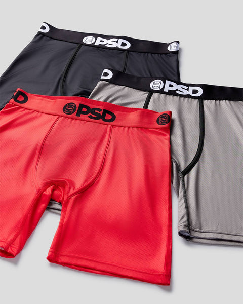 Three mesh briefs in red, gray, and black with PSD branded waistbands, displayed stacked.