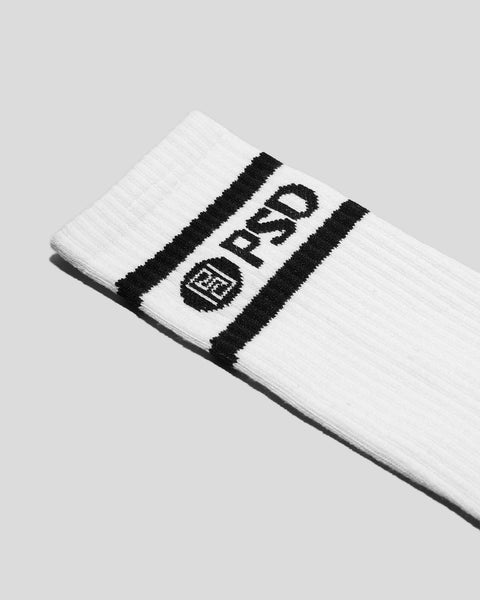 White crew socks with black logo stripe and text design across the calf.