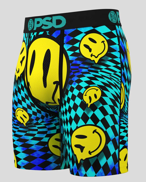 PSD brand boxer briefs with melting yellow smiley faces on cyan and black diamond pattern background.