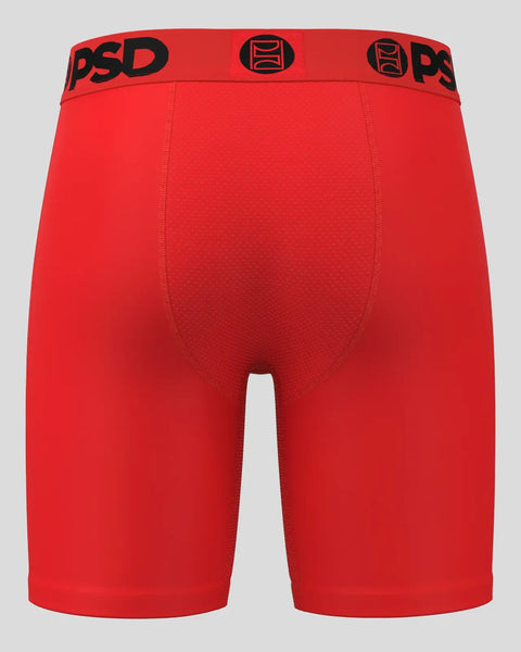 Red PSD brand athletic shorts with black waistband and logo displayed on gray background.