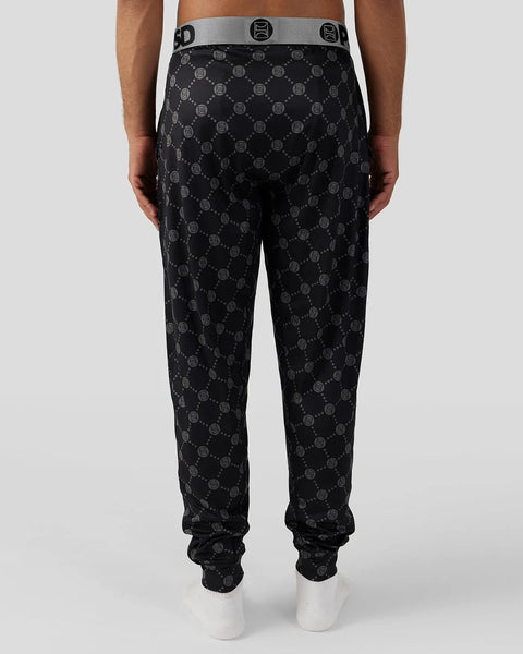 Black lounge pant with all-over monogram pattern and gray waistband with logo detail.