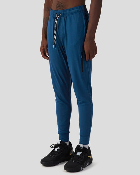 Deep teal joggers with drawstring waist, tapered cuffs, and side pocket detail on male model.