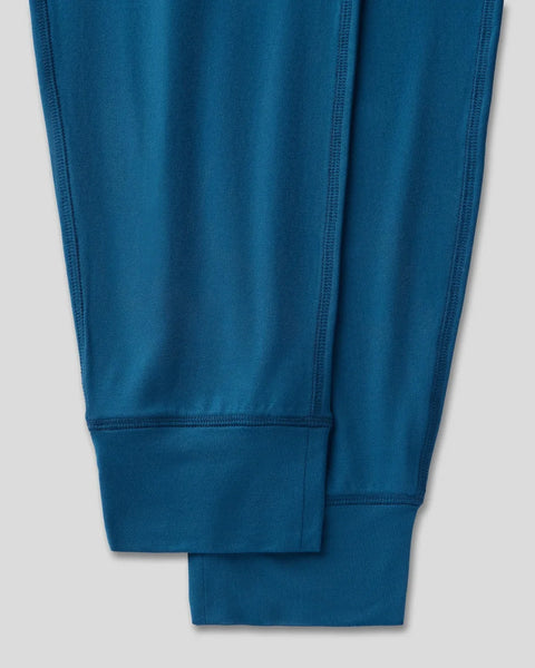 Deep teal joggers with ribbed cuffs and visible seam detailing, displayed flat on white background.