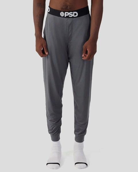Charcoal gray lounge pant with black PSD waistband and ribbed ankle cuffs.