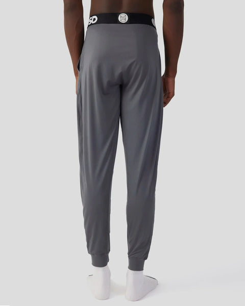 Charcoal lounge pants with black waistband and ribbed cuffs, shown from back view.