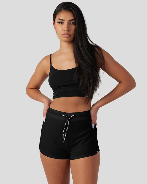 Black modal cami sleep set with thin straps and drawstring shorts on model.