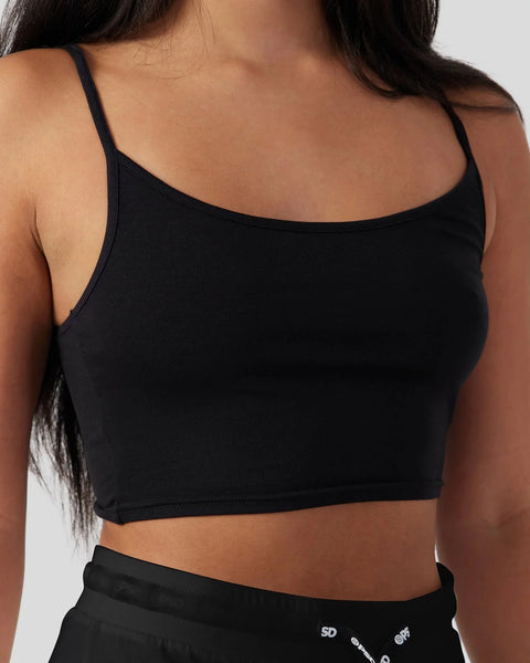 Black cami sleep set with thin straps and matching lounge bottoms visible at waist.