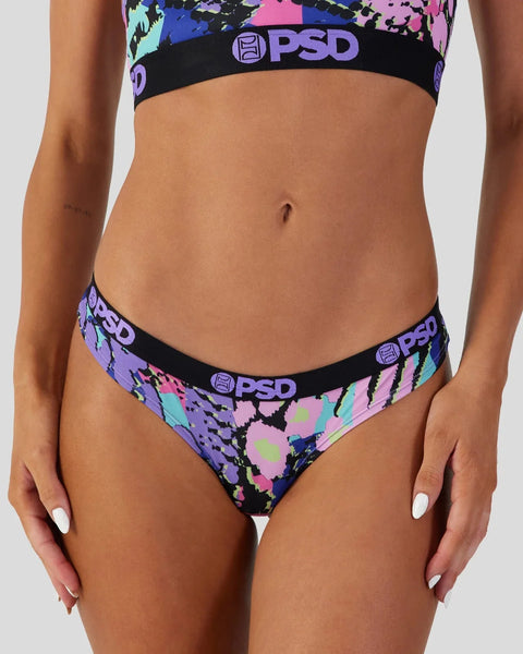 PSD brand bikini bottoms with neon floral and splatter print design on black background.