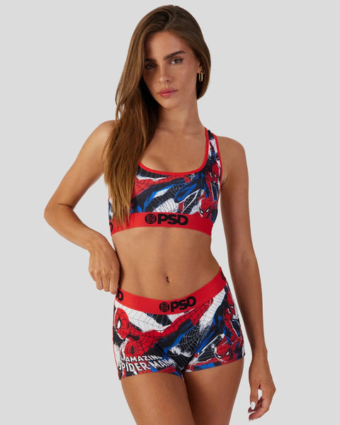 Woman wearing red Spider-Man print sports bra and shorts set with PSD branding.