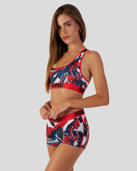 Woman wearing red Spider-Man print sports bra and shorts set with blue and white accents.