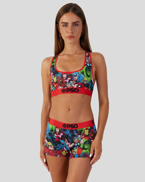 Woman wearing red and multicolor Avengers-print sports bra and matching shorts with PSD branding.