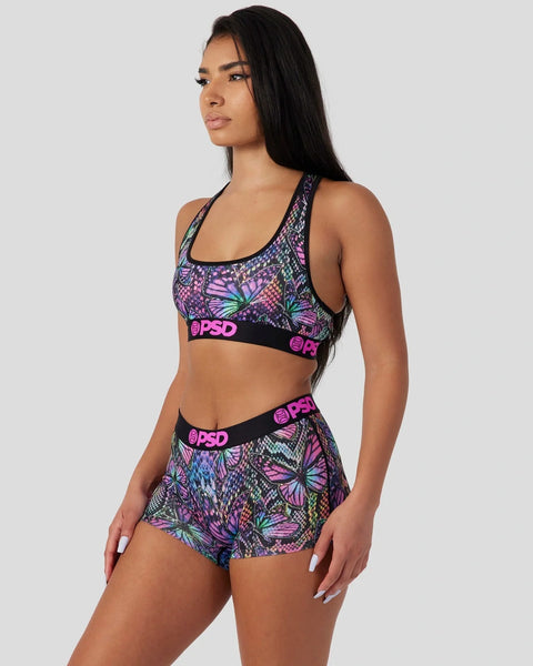 Colorful butterfly-print sports bra and shorts set with neon pink PSD waistband and black trim.
