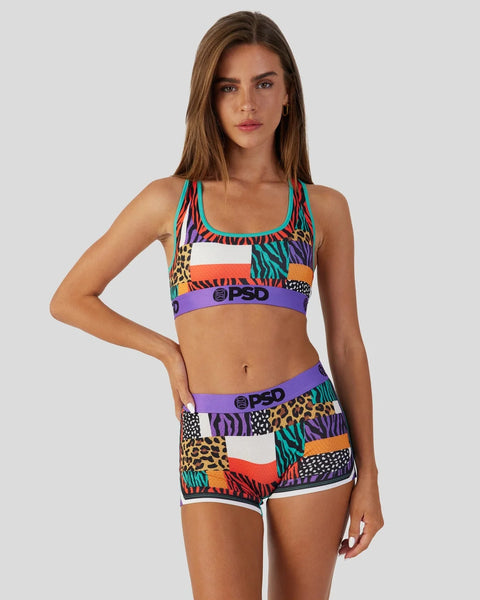Multicolor animal print sports bra and shorts set with purple waistband and logo detailing.