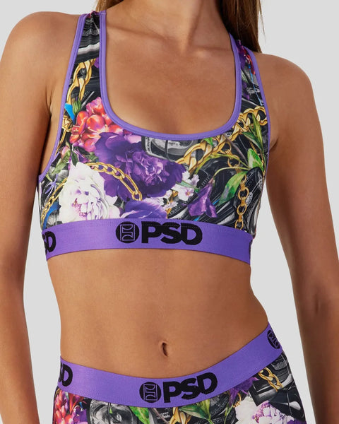 Sports bra with purple trim and floral print featuring gold chain and rose designs with PSD branding.