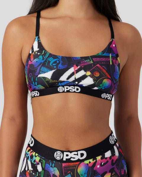Black sports bra with colorful Looney Tunes character graphics and PSD waistband.