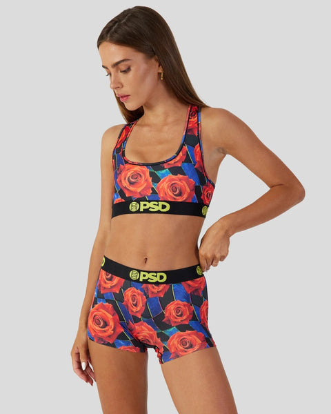 Women's two-piece athletic set with red rose print on navy background, black and yellow PSD waistbands.