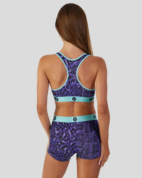 Purple leopard print sports bra and shorts set with turquoise trim and button details, shown from back view.