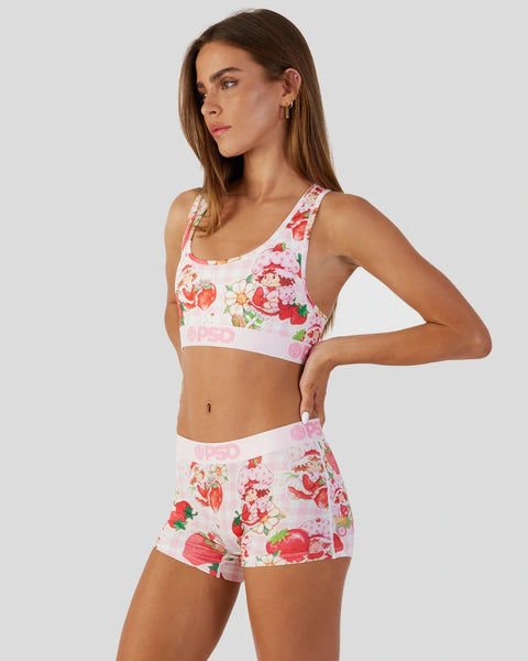 White sports bra and shorts set with red strawberry and floral print, pink waistband trim.